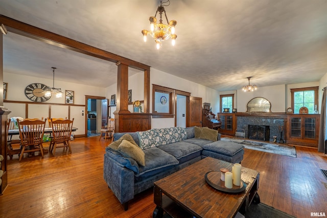 405 Washington St, Pekin, IL 61554 - living room featuring a chandelier, plenty of natural light, hardwood / wood-style flooring, and a premium fireplace