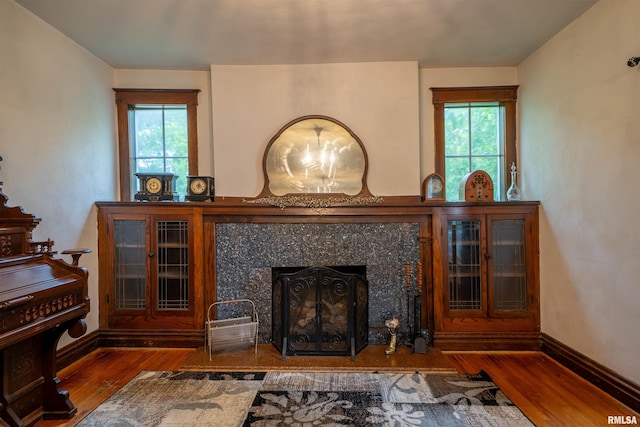 405 Washington St, Pekin, IL 61554 - living area featuring wood finished floors, healthy amount of natural light, a high end fireplace, and baseboards