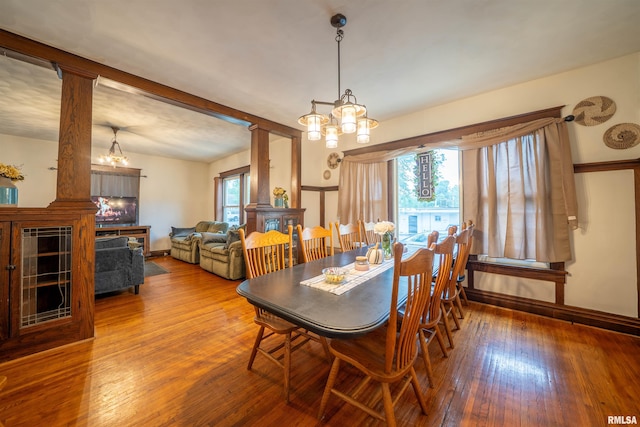 405 Washington St, Pekin, IL 61554 - dining room with wood-type flooring, a chandelier, and ornate columns
