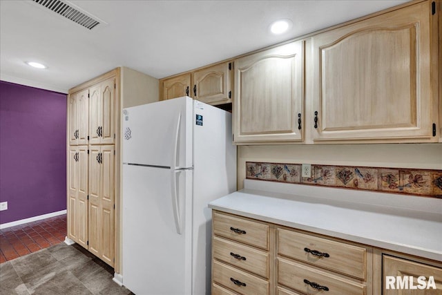 kitchen featuring freestanding refrigerator, light brown cabinetry, light countertops, recessed lighting, and baseboards