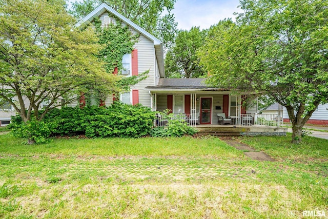 128 W Spruce St, Canton, IL 61520 - view of front of house with a porch and a front yard