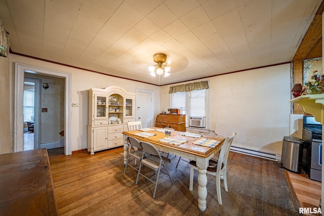 128 W Spruce St, Canton, IL 61520 - dining space with baseboard heating, wood finished floors, crown molding, and baseboards