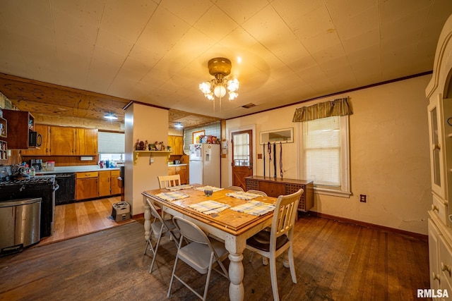 128 W Spruce St, Canton, IL 61520 - dining room featuring dark wood-type flooring and baseboards