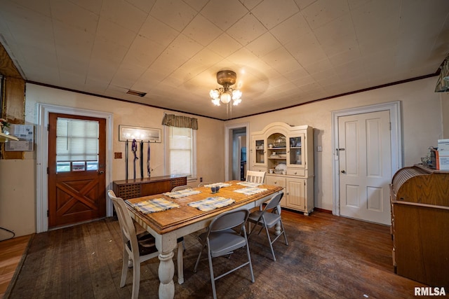 128 W Spruce St, Canton, IL 61520 - dining area featuring dark wood-type flooring and ornamental molding