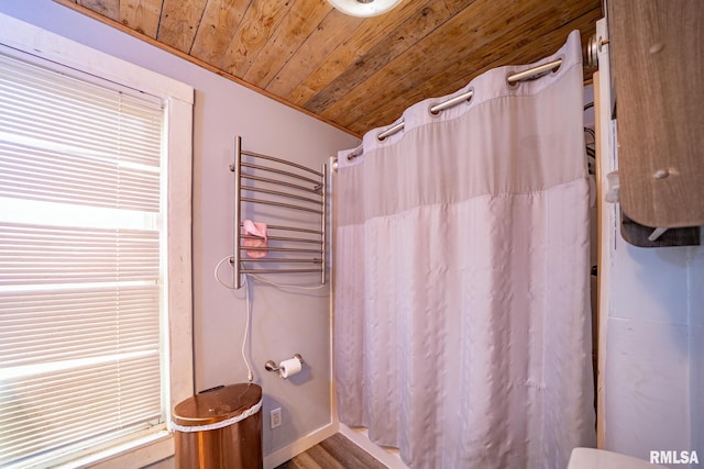 128 W Spruce St, Canton, IL 61520 - bathroom with wooden ceiling, curtained shower, baseboards, and radiator heating unit