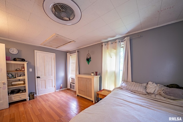 128 W Spruce St, Canton, IL 61520 - bedroom with attic access, wood finished floors, and ornamental molding