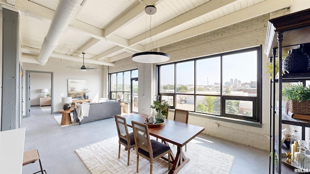 1001 SW Adams St Unit 304, Peoria, IL 61602 - dining space with finished concrete flooring, a ceiling fan, brick wall, beamed ceiling, and a view of city