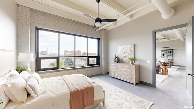 1001 SW Adams St Unit 304, Peoria, IL 61602 - bedroom with beamed ceiling, brick wall, and a ceiling fan