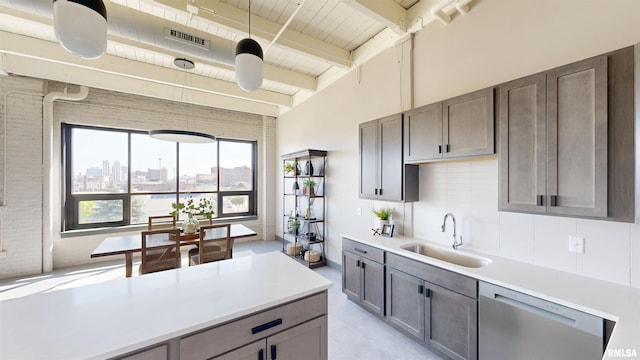 1001 SW Adams St Unit 304, Peoria, IL 61602 - kitchen with a sink, stainless steel dishwasher, light countertops, wooden ceiling with exposed beams, and backsplash