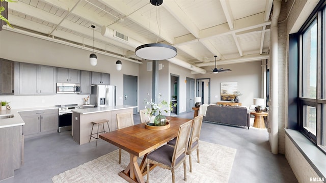 1001 SW Adams St Unit 304, Peoria, IL 61602 - dining area with finished concrete floors, ceiling fan, and beamed ceiling
