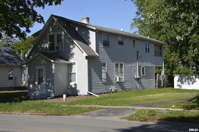 309 S Dudley St, Macomb, IL 61455 - view of front of property with a chimney, a front lawn, and cooling unit