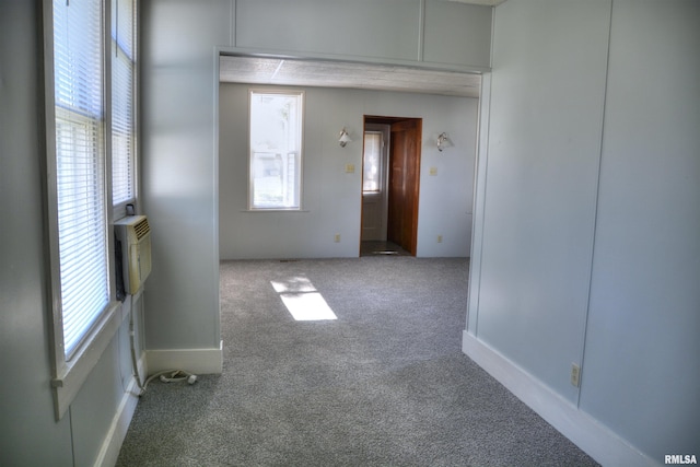 309 S Dudley St, Macomb, IL 61455 - carpeted spare room with plenty of natural light and a wall unit AC
