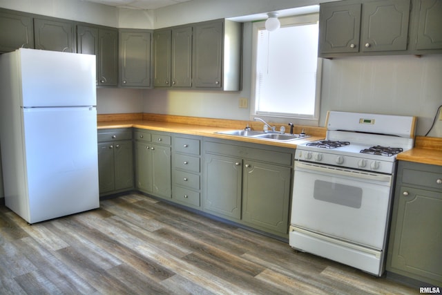 309 S Dudley St, Macomb, IL 61455 - kitchen featuring white appliances, a sink, gray cabinets, and wood finished floors