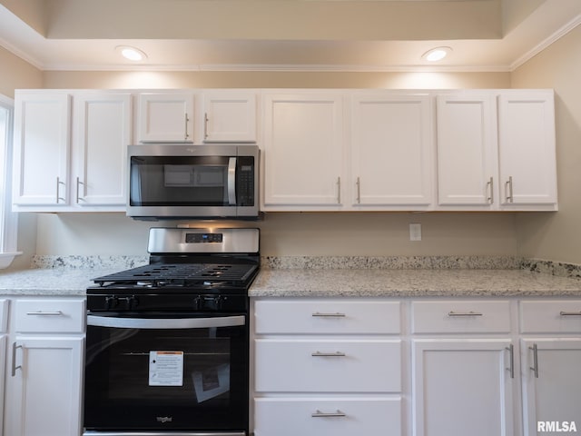 2205 N N St, Peoria, IL 61604 - kitchen featuring stainless steel appliances, white cabinets, crown molding, recessed lighting, and light stone counters