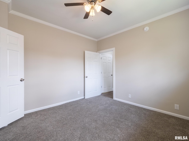 2205 N N St, Peoria, IL 61604 - carpeted empty room featuring ornamental molding, baseboards, ceiling fan, and a smoke detector