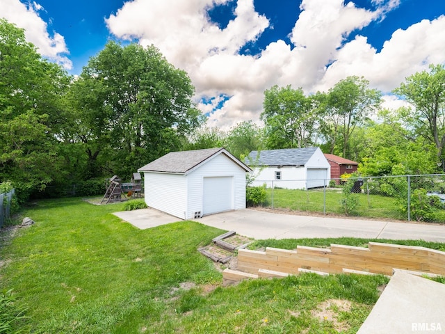 2205 N N St, Peoria, IL 61604 - view of yard featuring a detached garage, an outdoor structure, and driveway