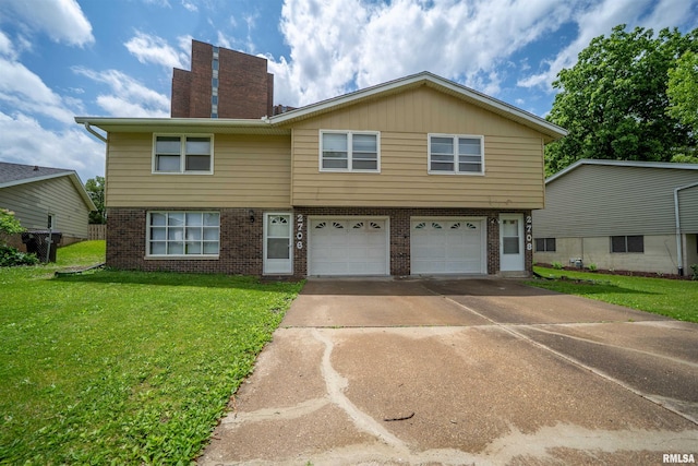 2706 W Millbrook Ct, Peoria, IL 61615 - townhome / multi-family property with brick siding, a garage, driveway, and a front yard