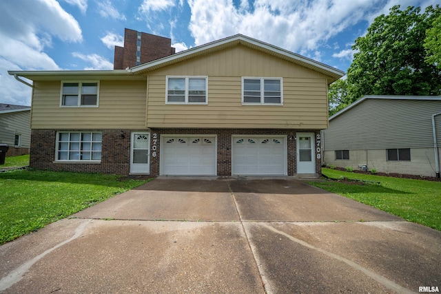 2706 W Millbrook Ct, Peoria, IL 61615 - multi unit property featuring brick siding, a garage, a front yard, and concrete driveway