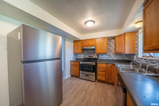 2706 W Millbrook Ct, Peoria, IL 61615 - kitchen featuring stainless steel appliances, under cabinet range hood, brown cabinetry, and light wood-style flooring