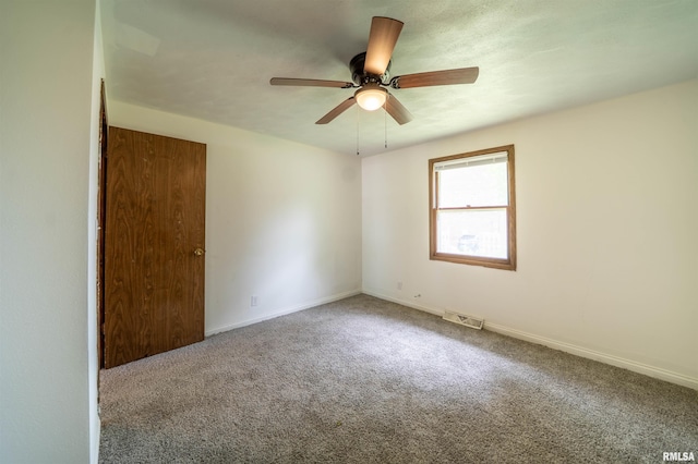 2706 W Millbrook Ct, Peoria, IL 61615 - spare room featuring carpet floors, a ceiling fan, and baseboards