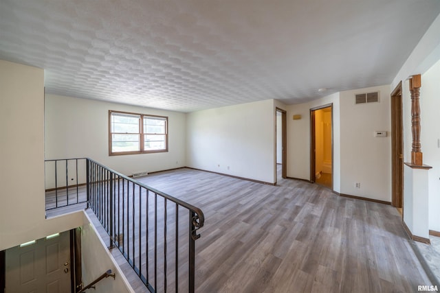 2706 W Millbrook Ct, Peoria, IL 61615 - unfurnished living room featuring wood finished floors and baseboards