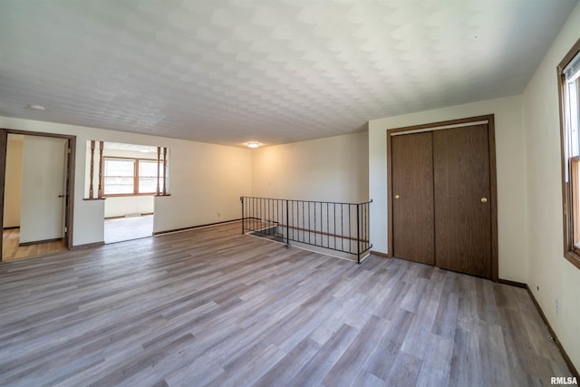 2706 W Millbrook Ct, Peoria, IL 61615 - unfurnished bedroom with a closet, wood finished floors, and baseboards