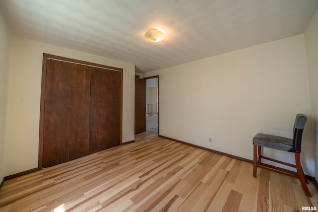 2706 W Millbrook Ct, Peoria, IL 61615 - unfurnished bedroom with a closet, light wood finished floors, and baseboards