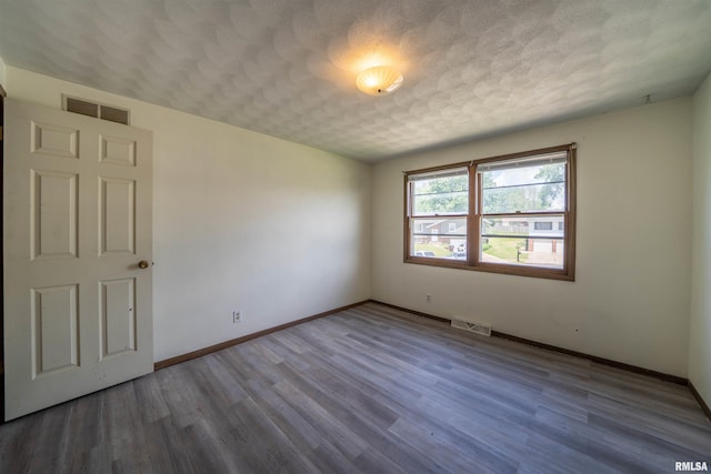 2706 W Millbrook Ct, Peoria, IL 61615 - empty room with baseboards, wood finished floors, and a textured ceiling