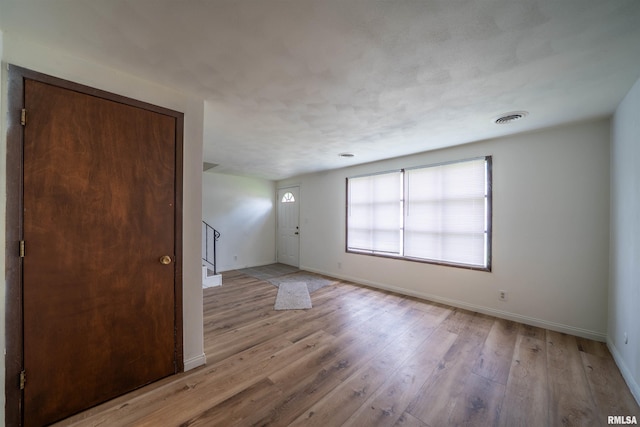 2706 W Millbrook Ct, Peoria, IL 61615 - spare room featuring baseboards, stairs, and light wood-type flooring