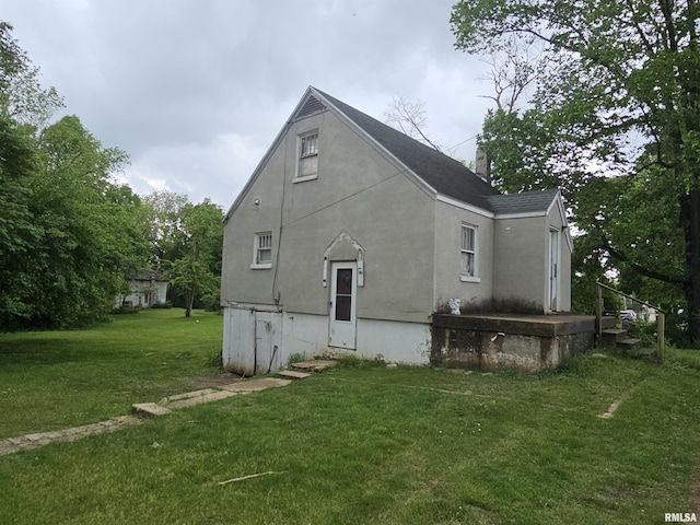 3304 E Washington St, East Peoria, IL 61611 - rear view of house with a lawn and stucco siding