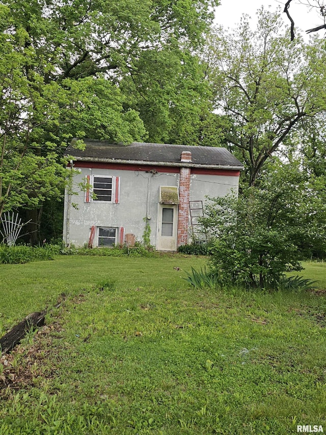 3304 E Washington St, East Peoria, IL 61611 - back of property with a yard, an outbuilding, and stucco siding