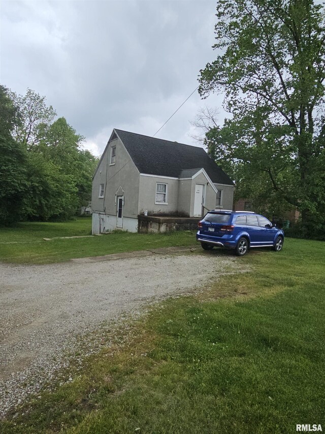 3300 E Washington St, East Peoria, IL 61611 - view of home's exterior with driveway and a lawn