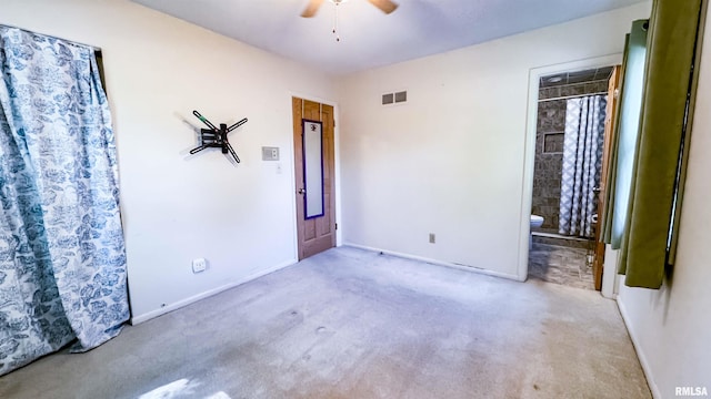7409 N Piccadilly Pl, Peoria, IL 61614 - unfurnished bedroom with carpet floors, ensuite bath, and ceiling fan