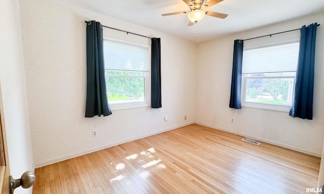 7409 N Piccadilly Pl, Peoria, IL 61614 - spare room featuring plenty of natural light, wood-type flooring, and a ceiling fan