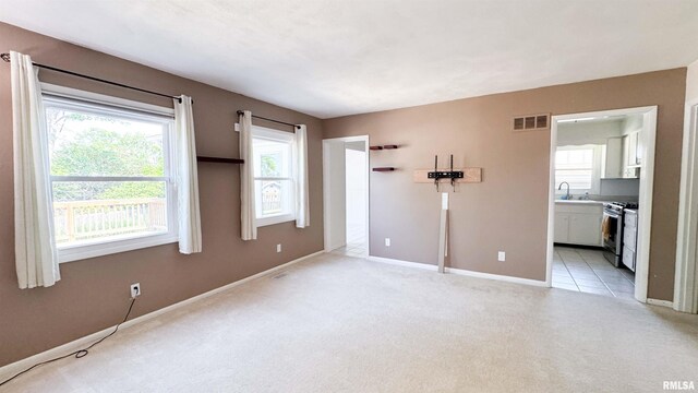 7409 N Piccadilly Pl, Peoria, IL 61614 - unfurnished bedroom featuring light colored carpet and connected bathroom