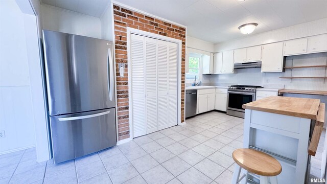 7409 N Piccadilly Pl, Peoria, IL 61614 - kitchen featuring stainless steel appliances, under cabinet range hood, open shelves, white cabinets, and light tile patterned floors