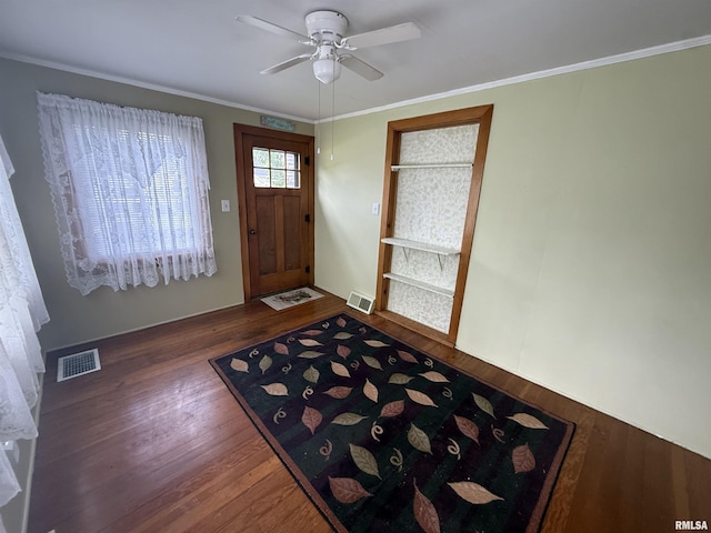 130 E Maple St, Roseville, IL 61473 - entrance foyer featuring dark wood finished floors, ceiling fan, and crown molding