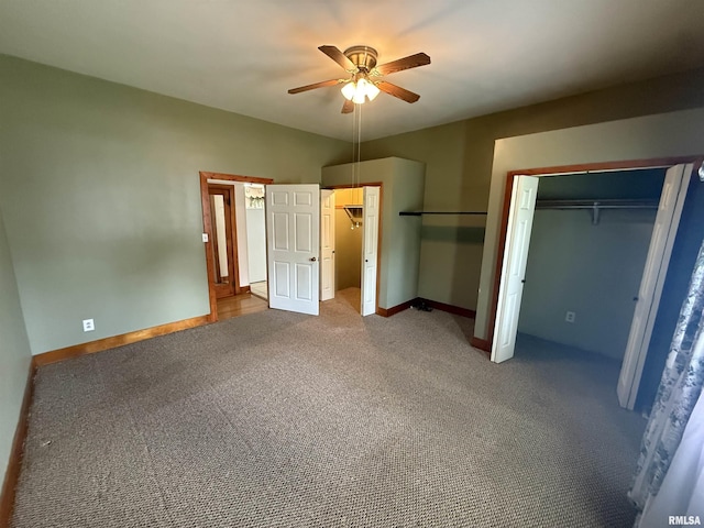 130 E Maple St, Roseville, IL 61473 - unfurnished bedroom featuring carpet floors, baseboards, a ceiling fan, and two closets
