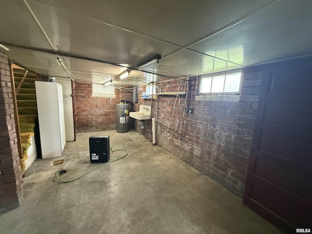 130 E Maple St, Roseville, IL 61473 - basement with brick wall and water heater