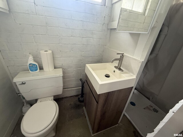 130 E Maple St, Roseville, IL 61473 - full bathroom featuring a shower stall, vanity, toilet, and unfinished concrete floors