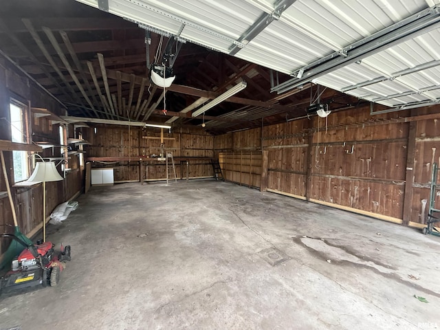 130 E Maple St, Roseville, IL 61473 - garage with wood walls and a garage door opener