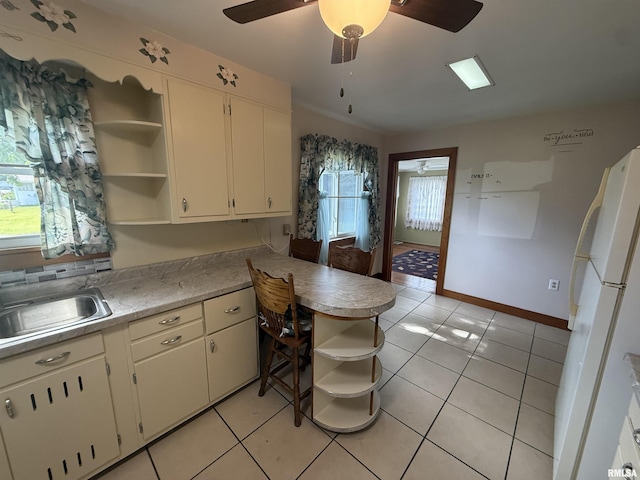 130 E Maple St, Roseville, IL 61473 - kitchen featuring open shelves, freestanding refrigerator, a sink, a peninsula, and white cabinets