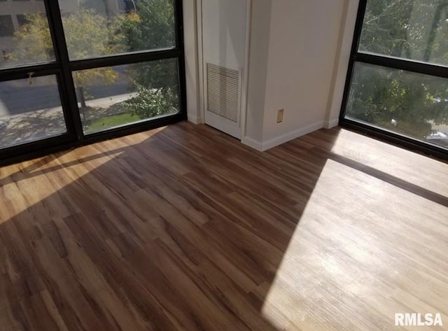 125 SW Jefferson Ave Unit W4S, Peoria, IL 61602 - empty room with baseboards and wood finished floors