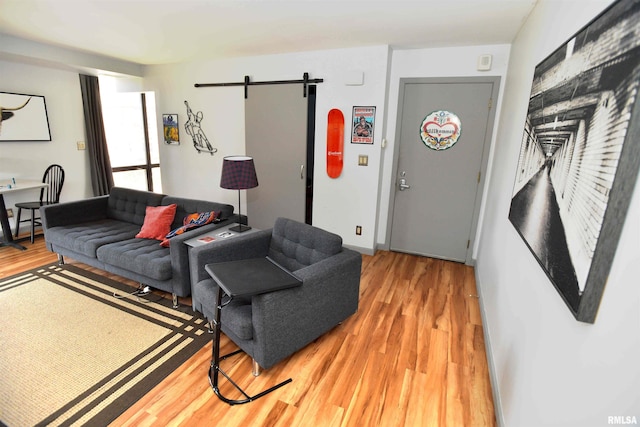 125 SW Jefferson Ave Unit W4S, Peoria, IL 61602 - living room with light wood finished floors, a barn door, and baseboards