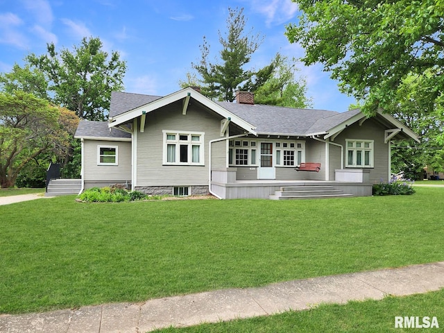 418 W Clinton St, Toulon, IL 61483 - view of front of home with a chimney, a front lawn, and roof with shingles
