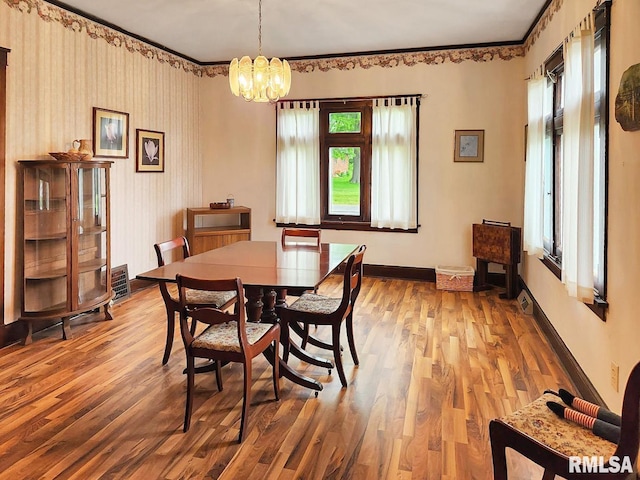 418 W Clinton St, Toulon, IL 61483 - dining area with wood finished floors, a chandelier, and baseboards