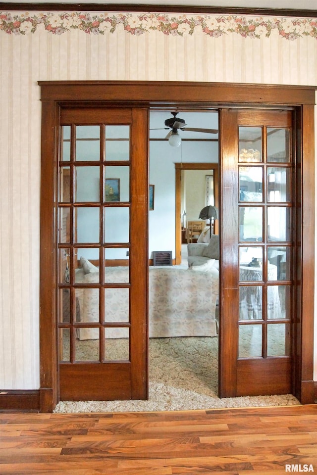 418 W Clinton St, Toulon, IL 61483 - detailed view of wood finished floors, french doors, and wallpapered walls