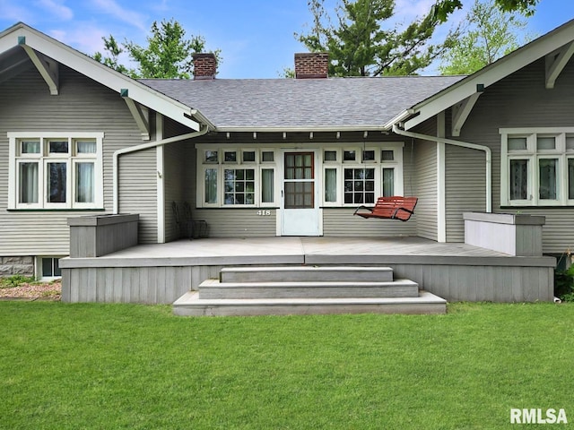 418 W Clinton St, Toulon, IL 61483 - back of house with a wooden deck, a chimney, a lawn, and a shingled roof