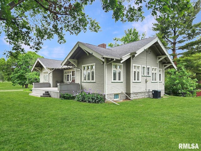 418 W Clinton St, Toulon, IL 61483 - view of property exterior with a chimney, a lawn, central AC, and a deck
