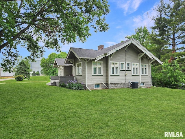 418 W Clinton St, Toulon, IL 61483 - view of side of property featuring a chimney, a yard, a deck, and central air condition unit